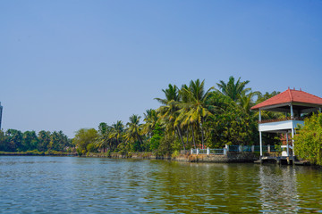 Fototapeta na wymiar Beautiful river side tree and house view in kochi Kerala India.