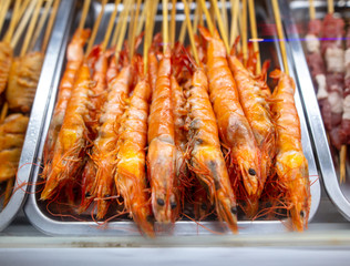 Shrimps on wooden sticks for grilling.