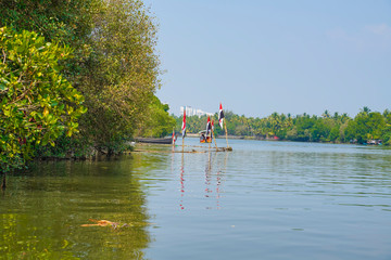 River side view with coconut tree and house in alleppey. Kerala 