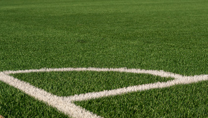 Artificial green grass and white border lines. Artificial turf for soccer field. Football field in an outdoor stadium. Selective focus © Марина Мартьянова