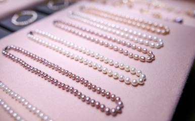 Pearl beads on a pink counter