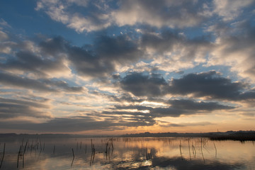 sunrise over the lake. cloudy sky.