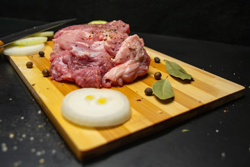  Fresh meat on a cutting board, onions and peppers