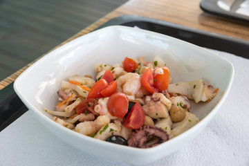 Fish salad with tomatoes and olives