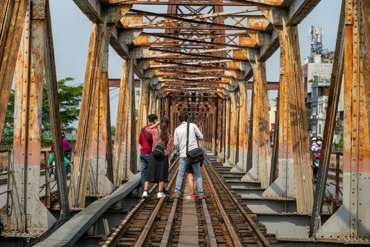 Railways on Long Bien ancient metal bridge with people taking photo on railways - Powered by Adobe