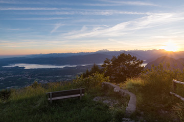 Obraz premium Big european lake and the Alpine chain at sunset. Lake Maggiore with the Alps and the Monte Rosa in the background. Scenic aerial view from the Campo dei Fiori regional park of Varese