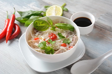 Traditional Vietnamese soup Pho bo with herbs,beef, rice noodles,chili and bean sprouts . Vietnamese Cuisine. Asian food