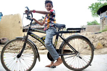 The Indian rural child is blissful with his bicycle