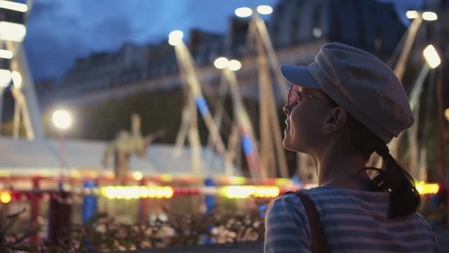 Young girl at an amusement park at night, Paris
