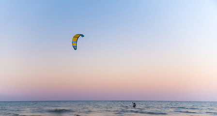 kitesurfing on the blue sea on a bright Sunny day