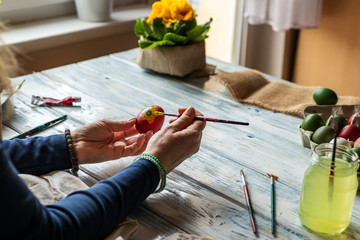 Woman painting traditional Easter eggs