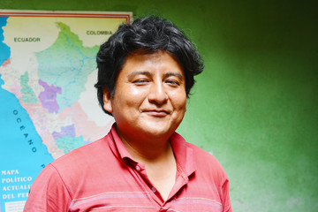 Peruvian man smiling. A map of Peru in the background.