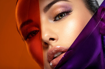 Beautiful white girl with bright eye-makeup. Beautiful fashion woman with  a colored  items.  ...