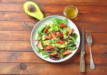 Poke bowls with fresh salmon, crystal noodles, radish, avocado, sweet pepper, cucumber, sesame seeds, red cabbage. Organic food. Fresh seafood recipe. Food concept poke bowl on wooden background