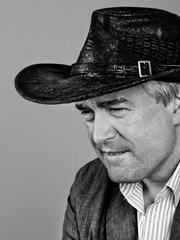 A respectable grey-haired Latino male in a hat.