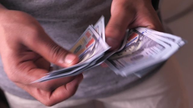 close up of man hand counting cash 
