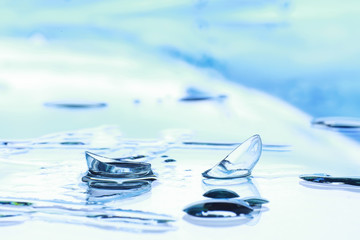 Tools for vision correction. Glasses and lenses with diopters on the background of splashes and...