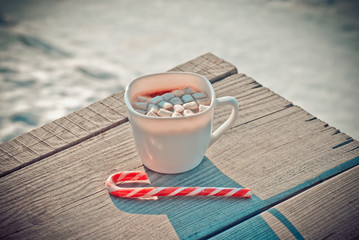 Good New Year spirit. Cocoa mug with sweet canes.
