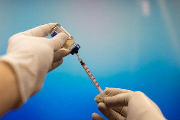 Doctor picking up insulin in a syringe close-up. Diabetes.