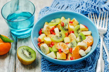 Healthy fruit salad on wood background