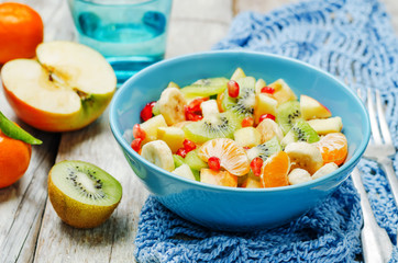 Healthy fruit salad on wood background