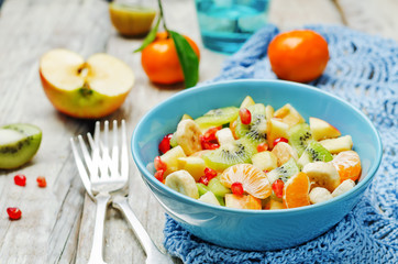 Healthy fruit salad on wood background