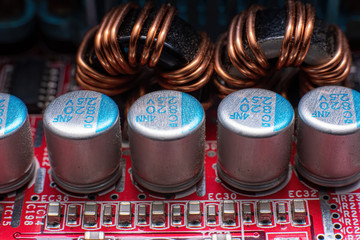 transistors and coils on a red motherboard