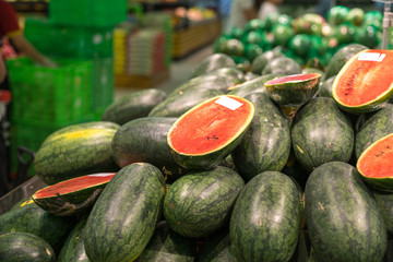 Fresh healthy fruits on shelves in supermarket