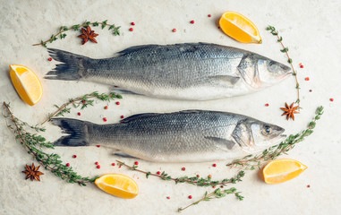 Raw whole seabass fish on the rustic background. Selective focus. Shallow depth of field.