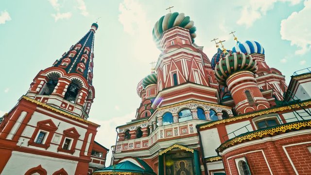 Beautiful close up of the colorful St Basil's Cathedral as sunshine filters through the tall spires and domes on a summer's day in Moscow. 