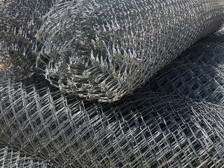 Rolled chain-link fence. Metal mesh netting rolled into rolls