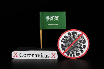 National flag of Saudi Arabia with cell of covid-19 and word coronavirus. Fast spreading disease worldwide. Covid-2019 is a stronger flu which affects seniors and sick people. Dangerous and agressive
