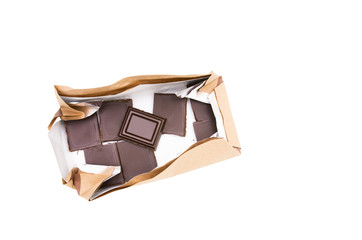 Dark chocolate pieces in a pack isolated on white background with clipping path. Top view
