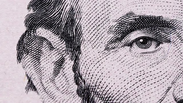 Sliding video of a five US dollar bill note, showing the portrait of US President Abraham Lincoln. Macro shot. Close up.