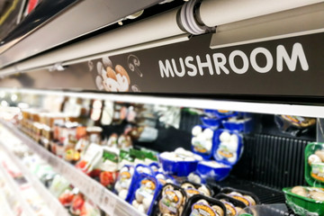 Mushroom signage at supermarket with defocused background