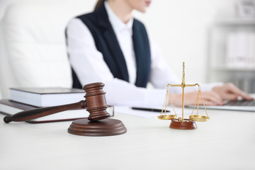 Judge gavel with scales on table of notary public in office