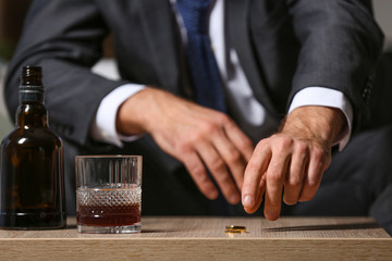 Divorced man drinking cognac at home. Concept of alcoholism