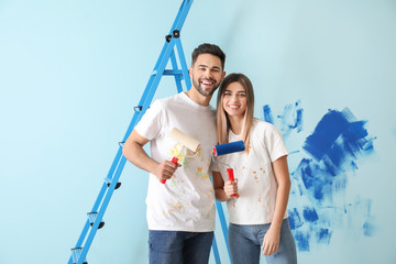 Happy young couple doing repair in their new house