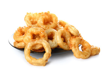 Plate with crispy fried onion rings on white background