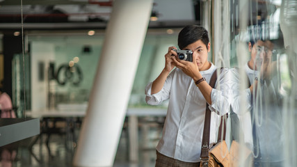 Man's hands holding vintage old camera