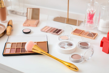 Different cosmetics on table of makeup artist