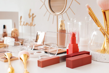 Different cosmetics on table of makeup artist