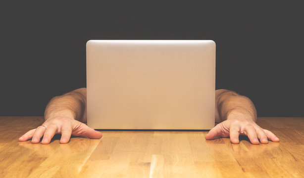 Mr. Computer concept. Unusual milenials surfs online. Hands near the computer without a head.