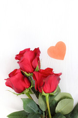 bouquet of roses and a small heart. tender love greetings