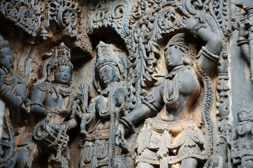 Fototapeta na wymiar Carved idols on the outer wall of Hoysaleswara temple, is a 12th-century Hindu temple dedicated to lord Shiva, Halebeedu, Karnataka, India