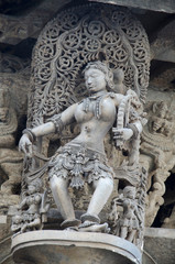 Fototapeta na wymiar Carved sculptures on the outer wall of the Chennakeshava Temple complex, 12th-century Hindu temple dedicated to lord Vishnu, Belur, Karnataka, India