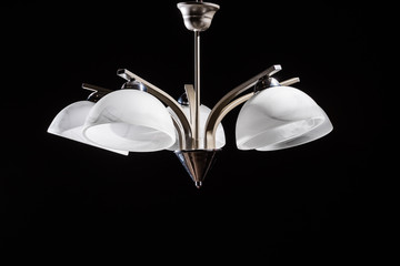 Modern lamp, chandelier on a black background. Lighting element of the interior. environmental materials of lamps