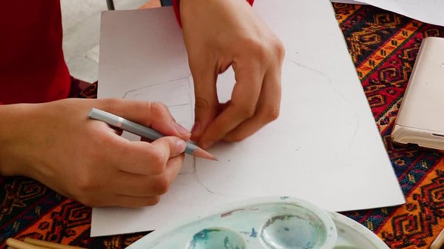 Children learn to draw. girl makes a sketch of the future drawing