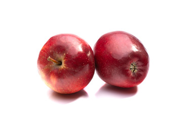two red ripe apples close up on a white isolated background