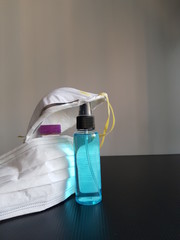 Closeup of ethyl alcohol and masks.  Prevention of Coronavirus Covod-19 concept.